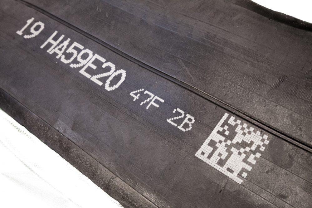 Uncured rubber with human readable text and 2D code made with V-Series drop-on-demand marking system 