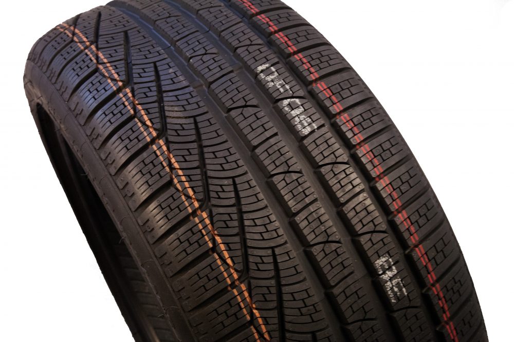 Rubber tire with striping and human readable text mark made by pigmented ink and valve jet