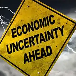 Economic uncertainty ahead road sign.