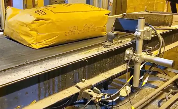 LCY company marks on bags going down a conveyor. 